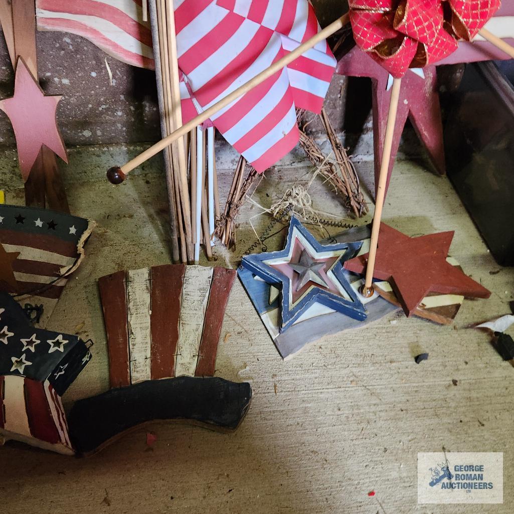 Lot of patriotic decorations including plastic flag, wooden flags, bird houses and Uncle Sam