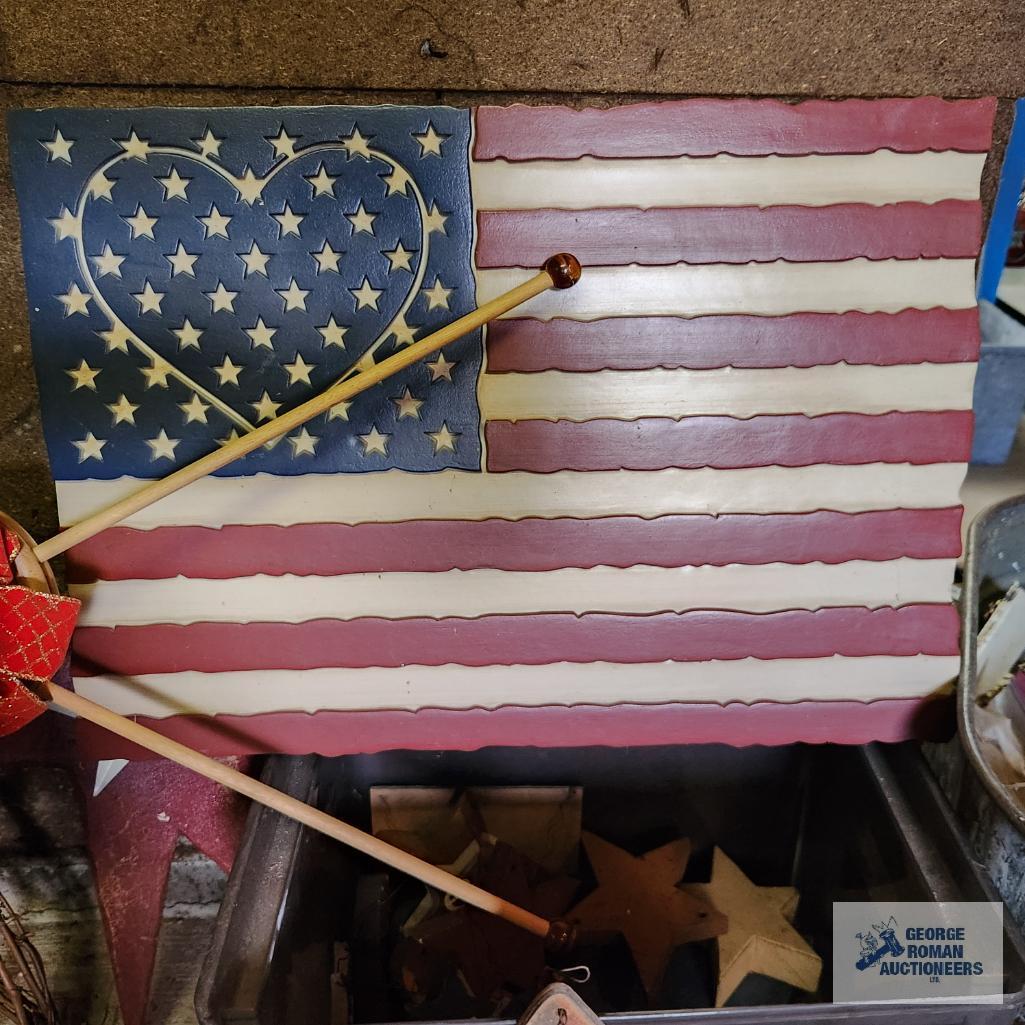 Lot of patriotic decorations including plastic flag, wooden flags, bird houses and Uncle Sam