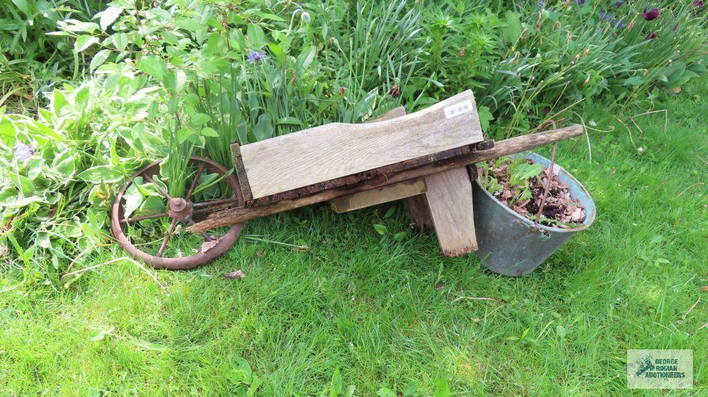 Antique wheelbarrow with copper bucket