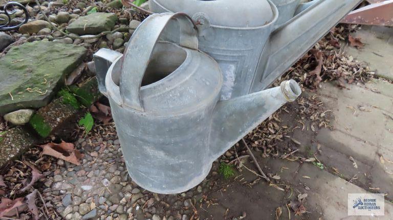 Three antique watering cans