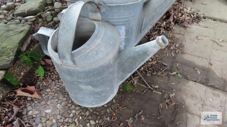 Three antique watering cans