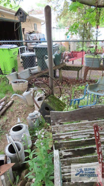 Lot of wooden and metal chairs, birdhouse, pitchfork, and children swings