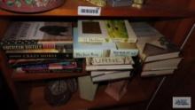 Shelf lot of leisure reading, including Nicholas Sparks. Mitch Albom. John Grisham.