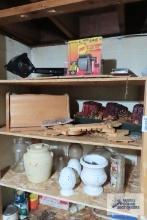 Contents of three shelves including breadbox, wooden decorations, candle, pencil sharpener, desk