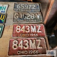 Four Ohio license plates including 1963 farm plate, 1964 plate, and (2) 1966 plates
