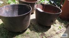 Cast iron cauldrons, one has holes