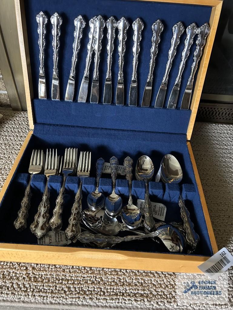 Service for 12 flatware by Oneida, Stainless. Includes serving pieces.