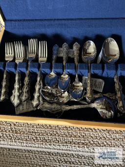Service for 12 flatware by Oneida, Stainless. Includes serving pieces.