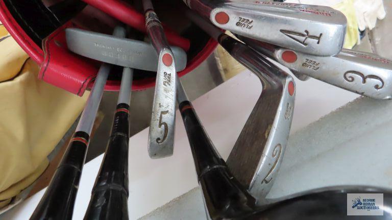 Golf bags with assorted clubs