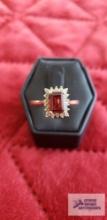 Gold colored ring with garnet gemstone...surrounded by diamonds 0.40 ct tw,... marked 14K PC 3.5 G