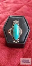 Silver colored ring with oval turquoise colored stone marked Sterling 4.3 G