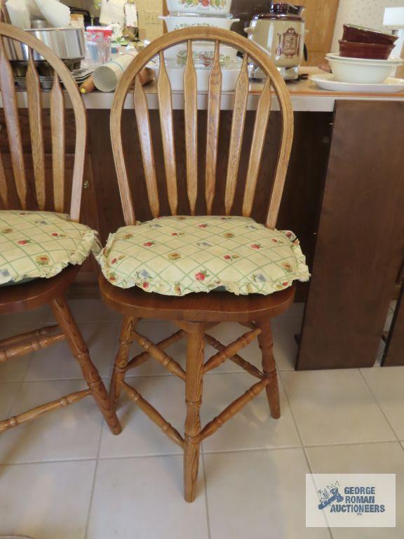 Two oak bar swivel stools. made in China