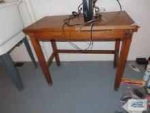 Oak children's writing desk in basement