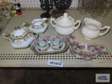 Two creamer and sugar sets, salt and pepper shakerson tray, and decorative dish