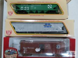 Three IHC ho gauge box cars new in boxes. one Ertl collectibles box car new in box.