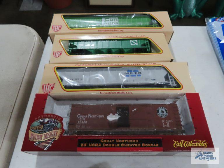 Three IHC ho gauge box cars new in boxes. one Ertl collectibles box car new in box.