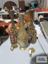 Brass like coat hooks, zodiac candle holders, and brass pitcher