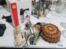 Electric knife, serving utensils, trivets, and other utensils. Biscuit machine, new in box.