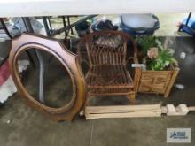 Child's rattan chair, planter, vintage frame, and wooden drying rack