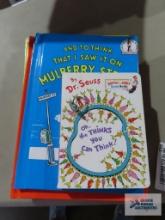 Variety of Dr. Seuss books and children's heart shaped ring