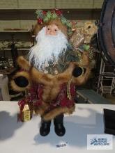 Santa Claus figurine with teddy bear and lantern