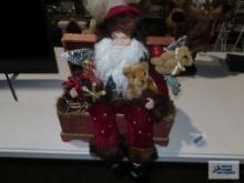 Santa Claus figurine sitting in chest