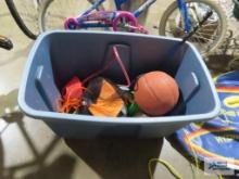 Tote with children's toys, football, basketball, watering can, etc