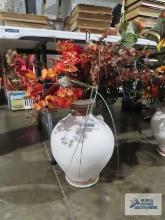 Two white pottery style vases with florals