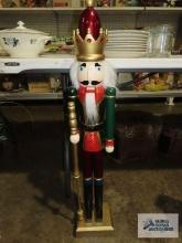 Wooden nutcracker wearing crown, approximately 3 ft tall.