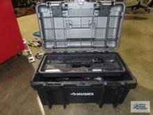 Husky plastic toolbox with various supplies and tools for bikes