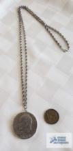 1972 Eisenhower one dollar coin pendant on silver colored chain marked Sterling and foreign coin