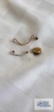 Gold colored tooth cap, ring band sizer marked 14K, and nose piece marked Shur-on