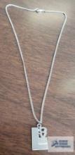 Silver colored Love pendant on silver colored chain, both marked Sterling