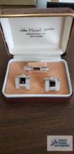 Silver colored tie clip and cufflinks marked Anson in John Mitchell Jewelers box
