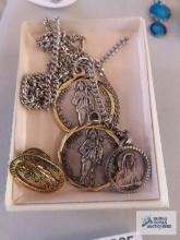 Religious pendants on costume jewelry chains and religious pin