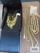 Gold multi strand necklace by Joan Rivers, pearl like and gold colored necklace by Nolan Miller,