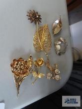 Variety of gold colored pins