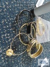Gold colored bracelets, one is Monet and one spoon bracelet