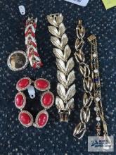 Gold colored bracelets, one beaded and two red colored