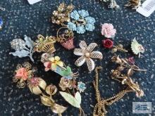 Variety of floral pins. One from Austria.