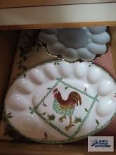 Rooster motif egg plate, milk glass egg plate with gold trim, and plastic trays