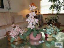 Ceramic duck planters and pink planter, all with flower arrangements