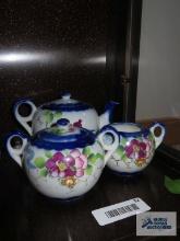 Oriental teapot, creamer and sugar. Creamer has been repaired.