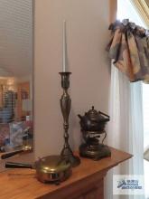 Heavy brass candlestick, bed warming pan, and tea kettle with warmer