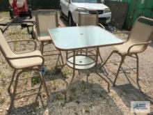 OUTDOOR TABLE WITH GLASS TOP. 4 CHAIRS. ONE BROKEN.