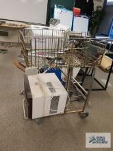 Variety of scrap metal including shopping cart, air conditioner, and handrails