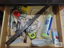 Variety of tools including measuring tapes, small hammer, pliers, etc