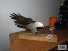Metal eagle figurine on wooden base