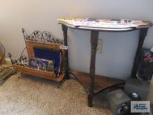 Wicker and metal magazine rackwith variety of books and small wall table