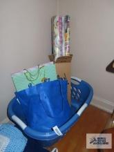 Wrapping paper, gift bags, and laundry basket